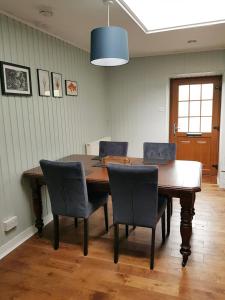 a dining room with a wooden table and chairs at Institution Road in Elgin