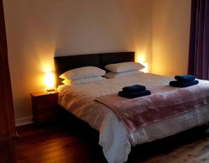 a bedroom with a bed with two towels on it at Institution Road in Elgin