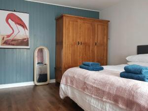 a bedroom with a bed and a dresser and a mirror at Institution Road in Elgin