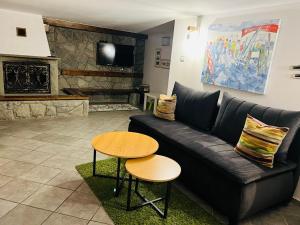 a living room with a black couch and a table at Villa Karola Stryi in Wisła
