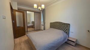 a bedroom with a bed and a mirror at Vytauto Apartments in Šiauliai