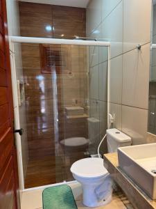 a bathroom with a toilet and a shower and a sink at Chalé do Comendador,Praia do Maceió-Camocim Ce in Camocim +6 photos