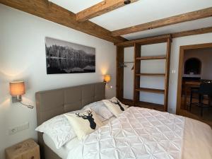a bedroom with a bed in a room with a table at Luxus Ferienwohnung Almhütte in Brixen im Thale