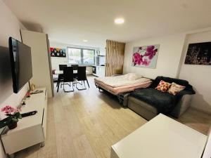 a living room with a couch and a bed at Moderne FerienWohnung NeuBau Merzig in Merzig