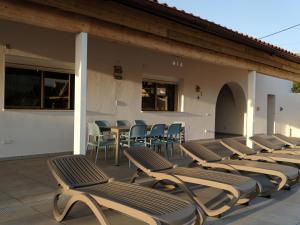 eine Reihe von Chaiselongues auf einer Terrasse in der Unterkunft Casa Da Liberdade 
