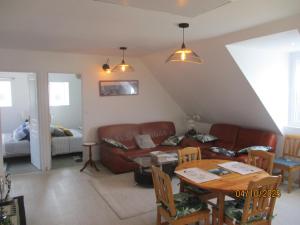 a living room with a couch and a table at Les Gites de Kerroyal in Garlan