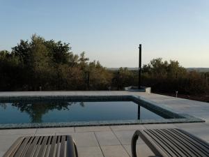 ein Schwimmbecken mit einer Bank daneben in der Unterkunft Casa Da Liberdade 