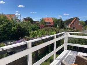 a white fence and a garden with purple flowers at Lovely villa for families and business traveler's in Aalborg