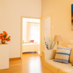 a living room with a couch and a bedroom at Calogiuri Nest in Lecce