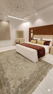 a large bedroom with a large bed and a carpet at النبلاء in Medina +37 photos