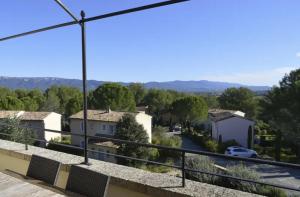 a view of a town from the balcony of a house at Appartement cosy en Provence in Mallemort