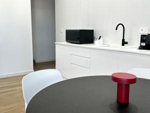 a red stool sitting on top of a table in a kitchen at Casa Rockfeller in Alghero