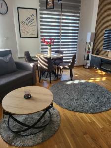 a living room with a couch and a table at Apartman Zlatibor in Zlatibor