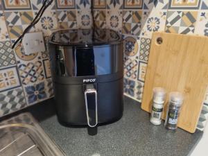 a coffee maker sitting on top of a kitchen counter at Village view apartment in Auldearn