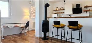a living room with two chairs and a wood stove at TESLA Creative Space in Odžaci