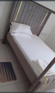 a bunk bed with white sheets and pillows on it at The Rittos in Mombasa +1 photo