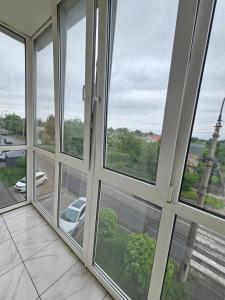 a room with four windows with a view of a street at 4х кімнатна квартира in Cherkasy