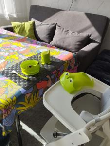 a high chair with a high table next to a couch at Ferienwohnung Moselherz in Reil +33 photos