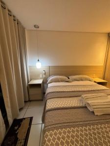 Postel nebo postele na pokoji v ubytování Apartamento à beira-mar