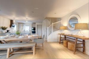 a kitchen and dining room with a table and chairs at No 1 The Hides Luxury House in North Norfolk in Titchwell