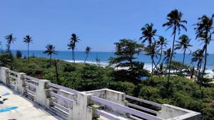 a view of the beach from a white fence at Marhba home stay in Varkala +68 photos