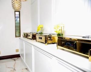 a room with white walls and a counter with sinks at Beyond Borders Guest House in Polokwane