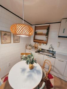 a kitchen with a white table with a plant on it at 소소가 in Samgong +16 photos