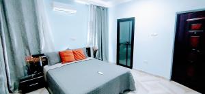 a bedroom with a bed and a window at Private Room En-suite at N Legon in North Legon