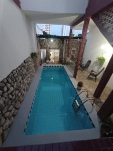 a swimming pool in the middle of a house at Hostel Goiabeiras in Cuiabá