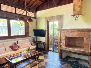 a living room with a couch and a fireplace at Villa Helios in Pai