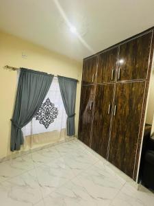 a room with wooden cabinets and a window at Furnished bedroom Apartment 