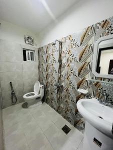 a bathroom with a toilet and a sink at Furnished bedroom Apartment 