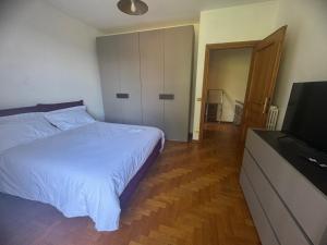 a bedroom with a bed and a flat screen tv at Come a Casa SLN in San Lorenzo Nuovo
