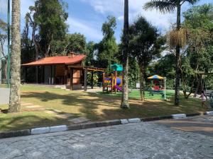 a park with a playground with a slide at Chale cabana 2 linda vista na serra da Cantareira in Caieiras