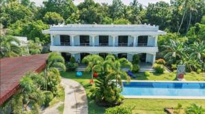 a large white house with a swimming pool at U And Me in Panglao Island
