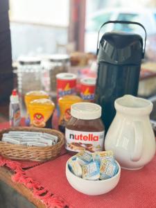 a table topped with a counter with food and a coffee maker at Pousada Casa das Rosas in Búzios