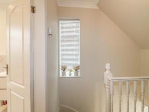 a white room with a window with two plants on a window sill at Alexandra Retreat in Skegby +9 photos