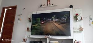 a large flat screen tv on a wall at Casa Cop 30 in Belém