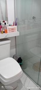 a bathroom with a toilet and a glass shower at Casa Cop 30 in Belém +1 photo