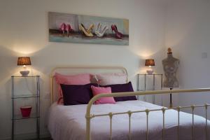 a bedroom with a bed with shoes on the wall at Émeraude baie Mont Saint Michel in Marcey-les-Grèves