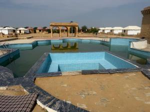 une piscine au milieu d'un désert dans l'établissement Desert offbit luxurious camp, à Jaisalmer