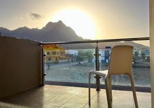 una silla sentada en un balcón con vistas a la montaña en MonteCara View T1, en Mindelo