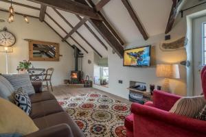 a living room with a couch and a fireplace at Lloft-Sarn in Sarn