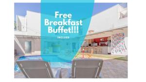 two chairs sitting in front of a swimming pool at Concept Design Hostel & Suites in Foz do Iguaçu