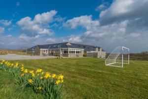 a house with a soccer goal in a field at Mynachdy-Sarn in Sarn