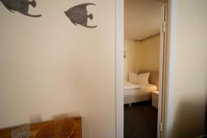 a room with a bedroom with a bed and a door at Haus Sonnenwinkel Bungalow 3 in Dahme