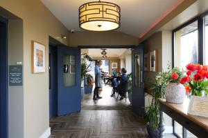 a man standing in the hallway of a restaurant at Doolin Inn in Doolin