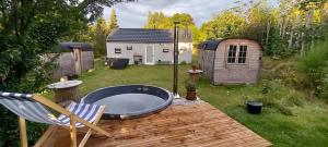 a hot tub sitting on a deck in a backyard at CentrumTrails in Ans