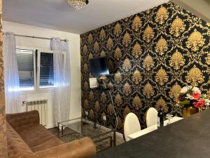 ein Wohnzimmer mit einer Couch und einem Fernseher an der Wand in der Unterkunft Oriente River Apartments by Paula de Assunção in Lisbon Humberto Delgado Airport