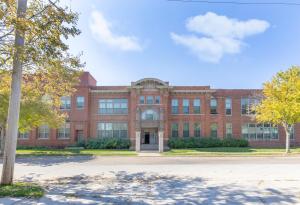 a large brick building with a tree in front of it at Boutique 1BR Condo - Walk to Memorial Stadium - Historic Hayward Place in Lincoln